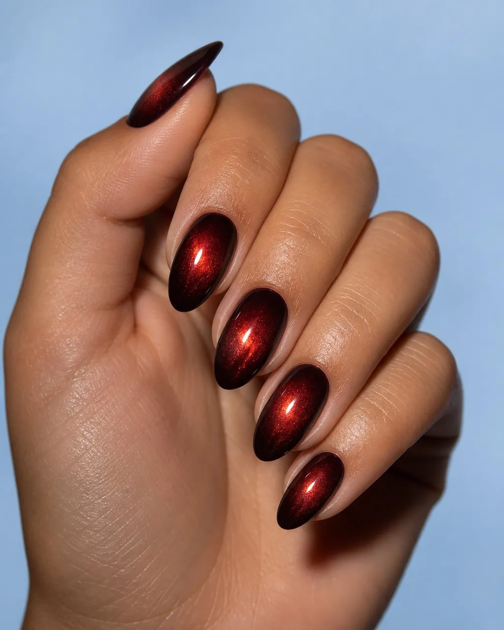 Black Cherry Halo — almond cat eye nails with near-black cherry magnetic cat-eye gel, magnet centred for a soft halo rather than a line…