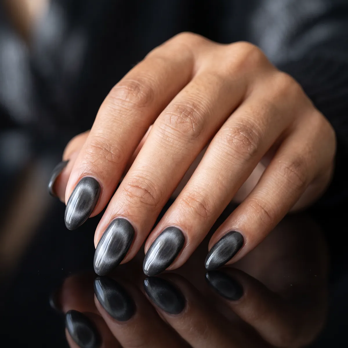 Graphite Aura — almond cat eye nails with use a charcoal gel base, pull the magnetic pigment into a soft centered halo, almond shape…