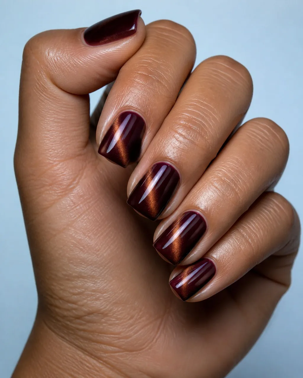 Oxblood Diagonal Flash — square cat eye nails with oxblood magnetic cat-eye with a warm bronze flash pulled into a sharp diagonal, glossy…