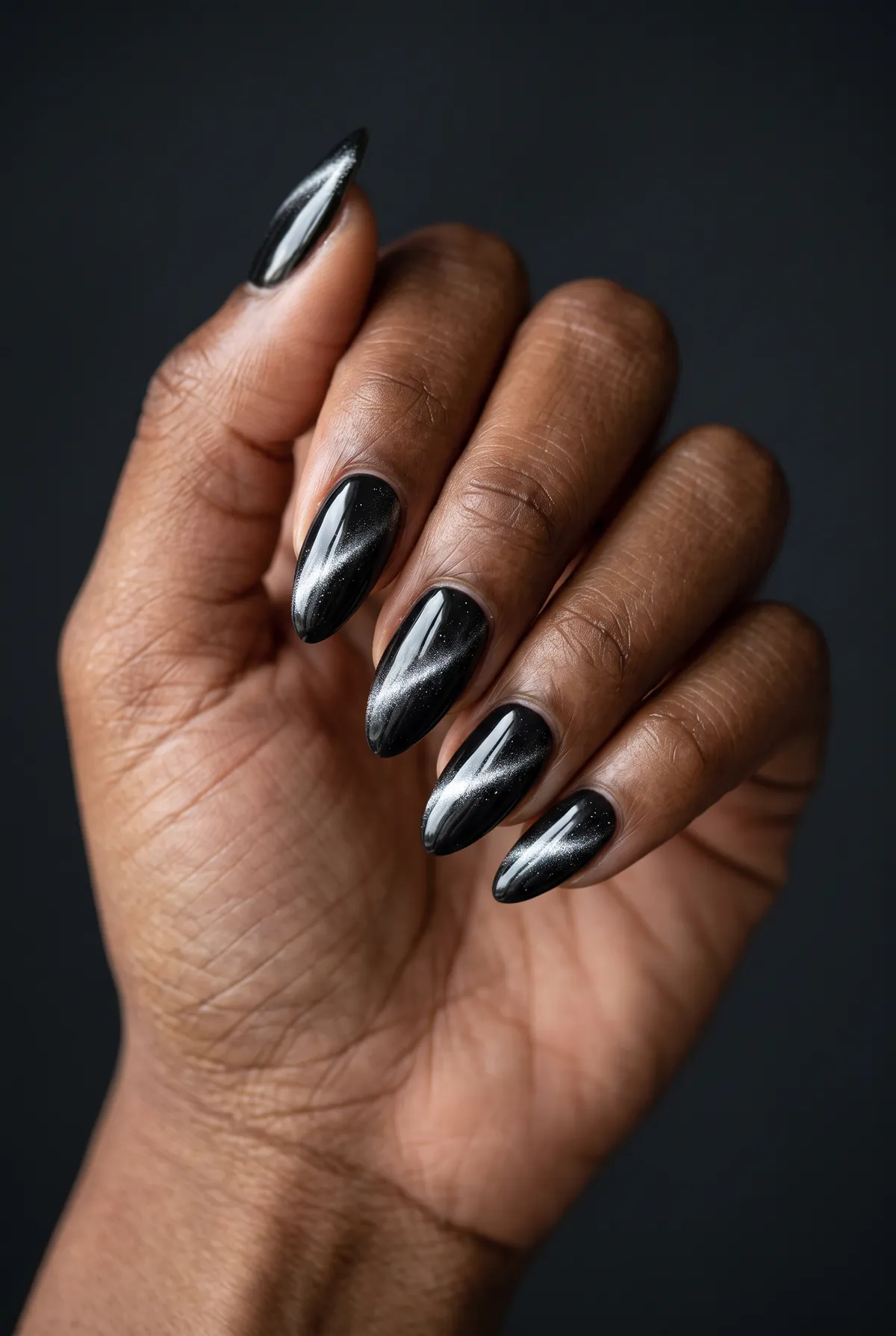 Silver Storm — almond cat eye nails with please apply a black gel base with a graphite magnetic top coat, drag the line diagonally, and…