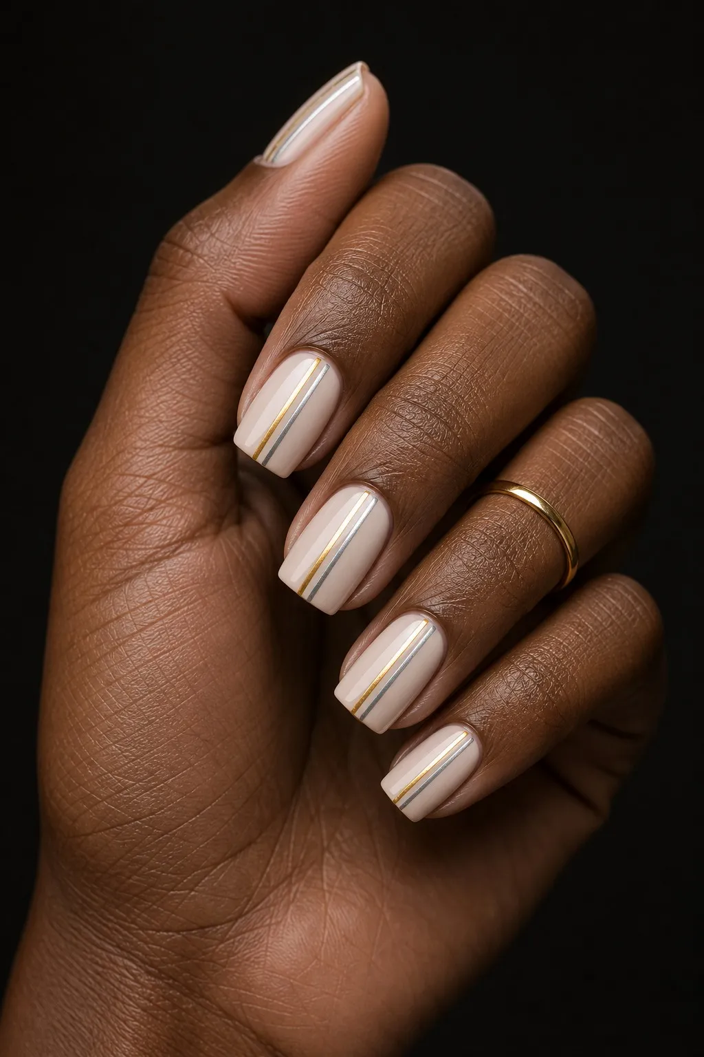 Chrome Stripe Art — square chrome nails with sheer nude base with two thin vertical chrome stripes, one silver and one gold, slightly off…