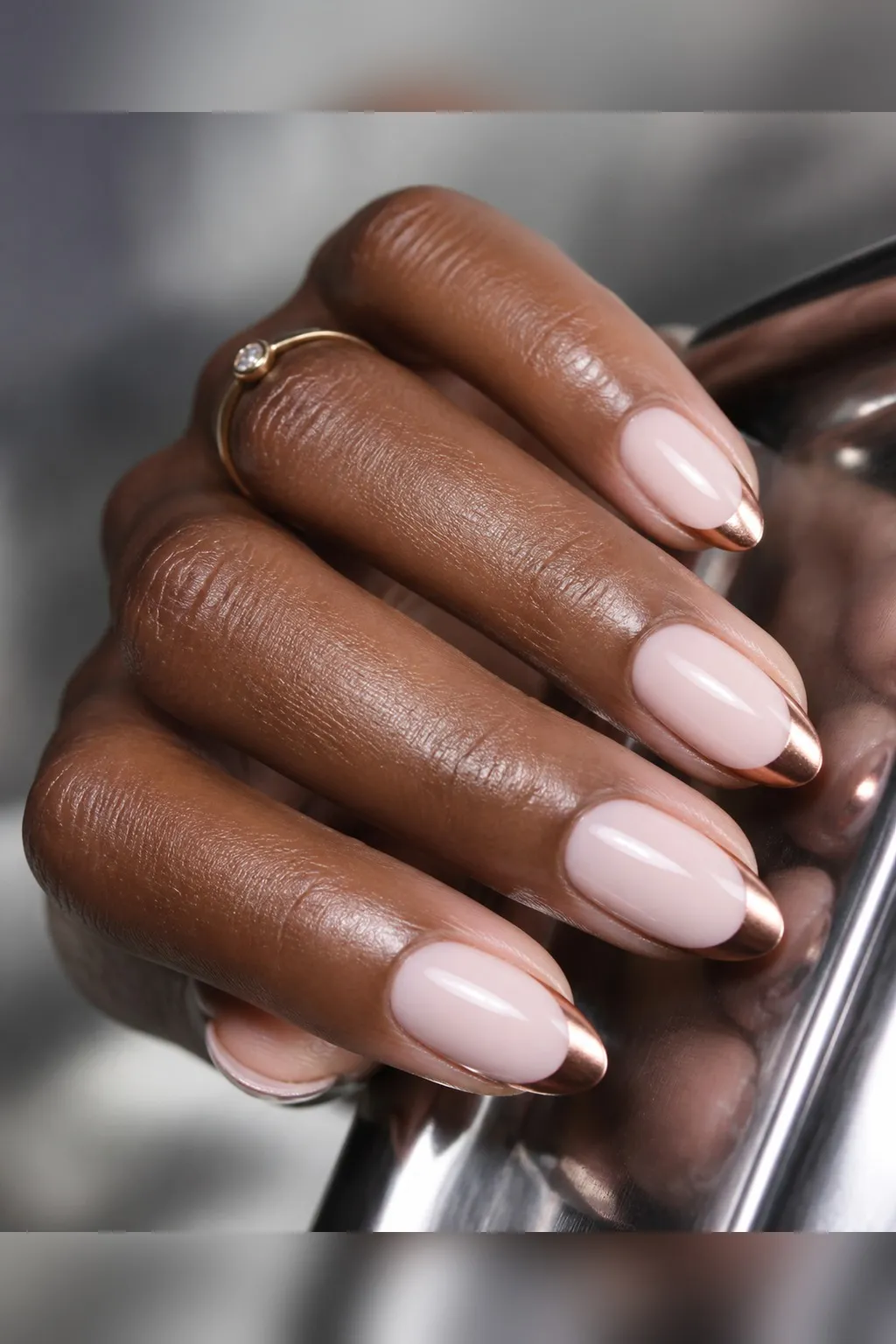 Rose Chrome French — almond chrome nails with sheer milky base with rose-gold chrome powder on the french tips only, crisp smile line…