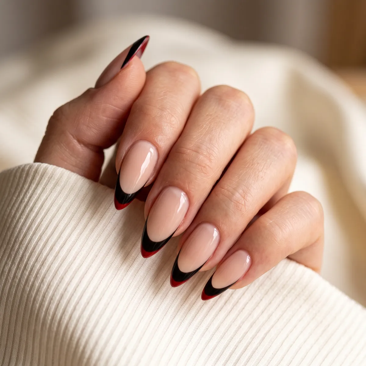 Fang Line French — stiletto halloween nails with do a nude base, sharp black french tip on stiletto nails with a hidden red underlayer at the tip