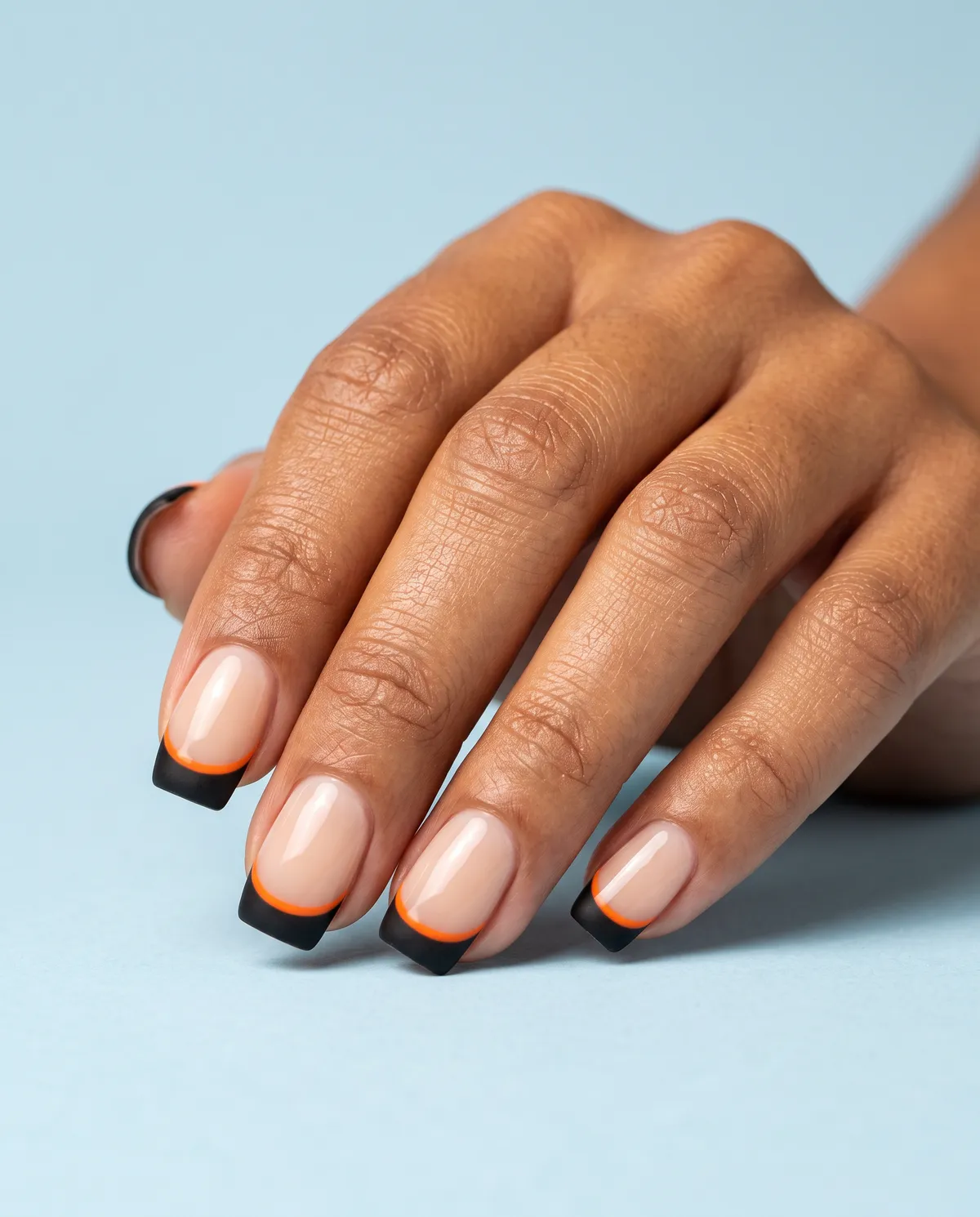 Ember Tip French — square halloween nails with paint a sheer nude base, add a matte black french tip with a thin orange line at the smile…