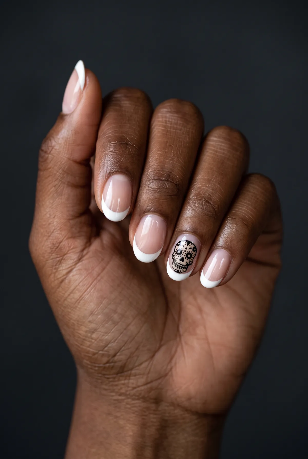 Sugar Skull Dot — round halloween nails with keep a classic white french on round nails, then hand-paint a mini sugar-skull dot on the ring…