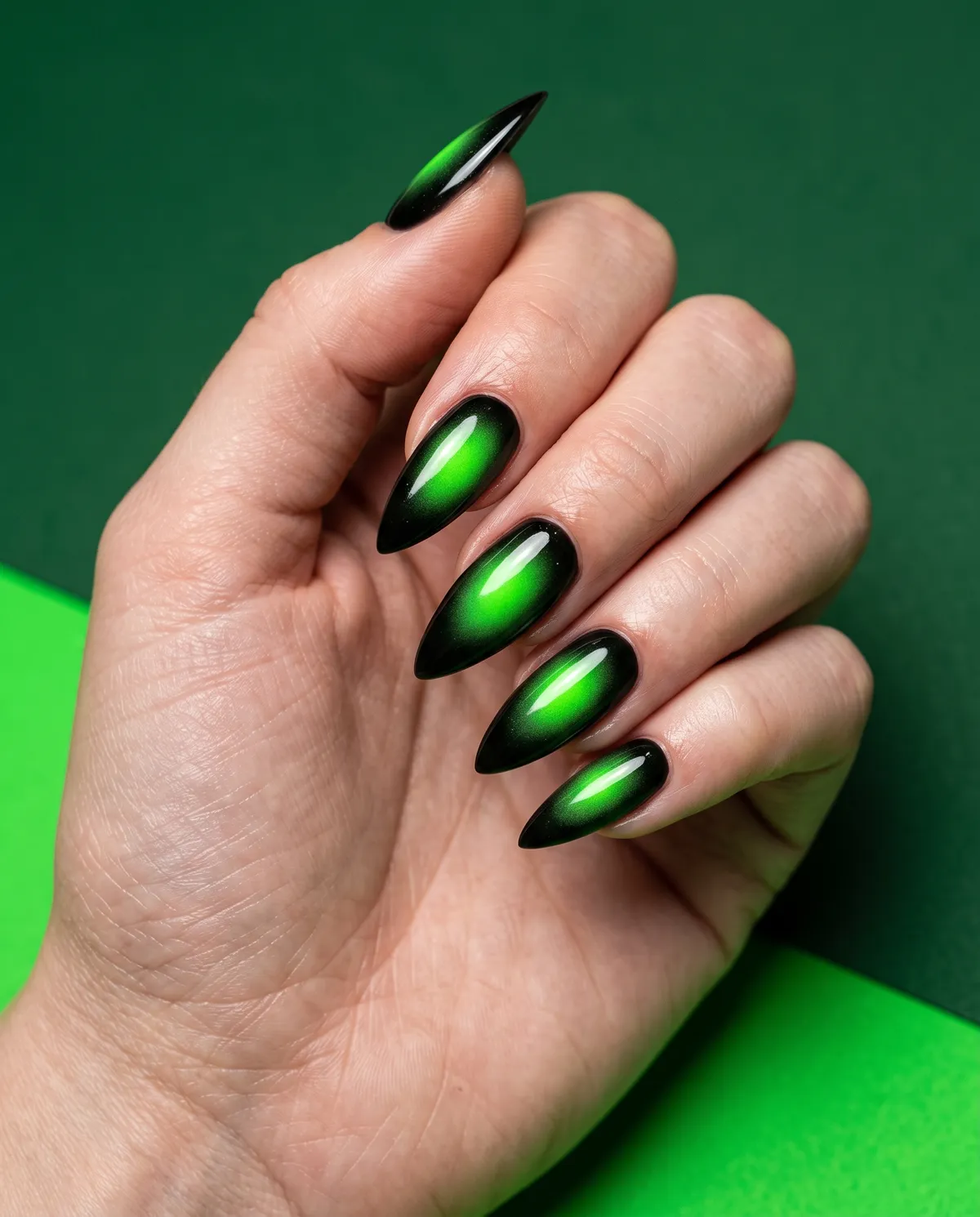 Toxic Aura Talon — stiletto halloween nails with airbrush a green aura bloom over a black gel base on stiletto nails, sealed with a glossy…
