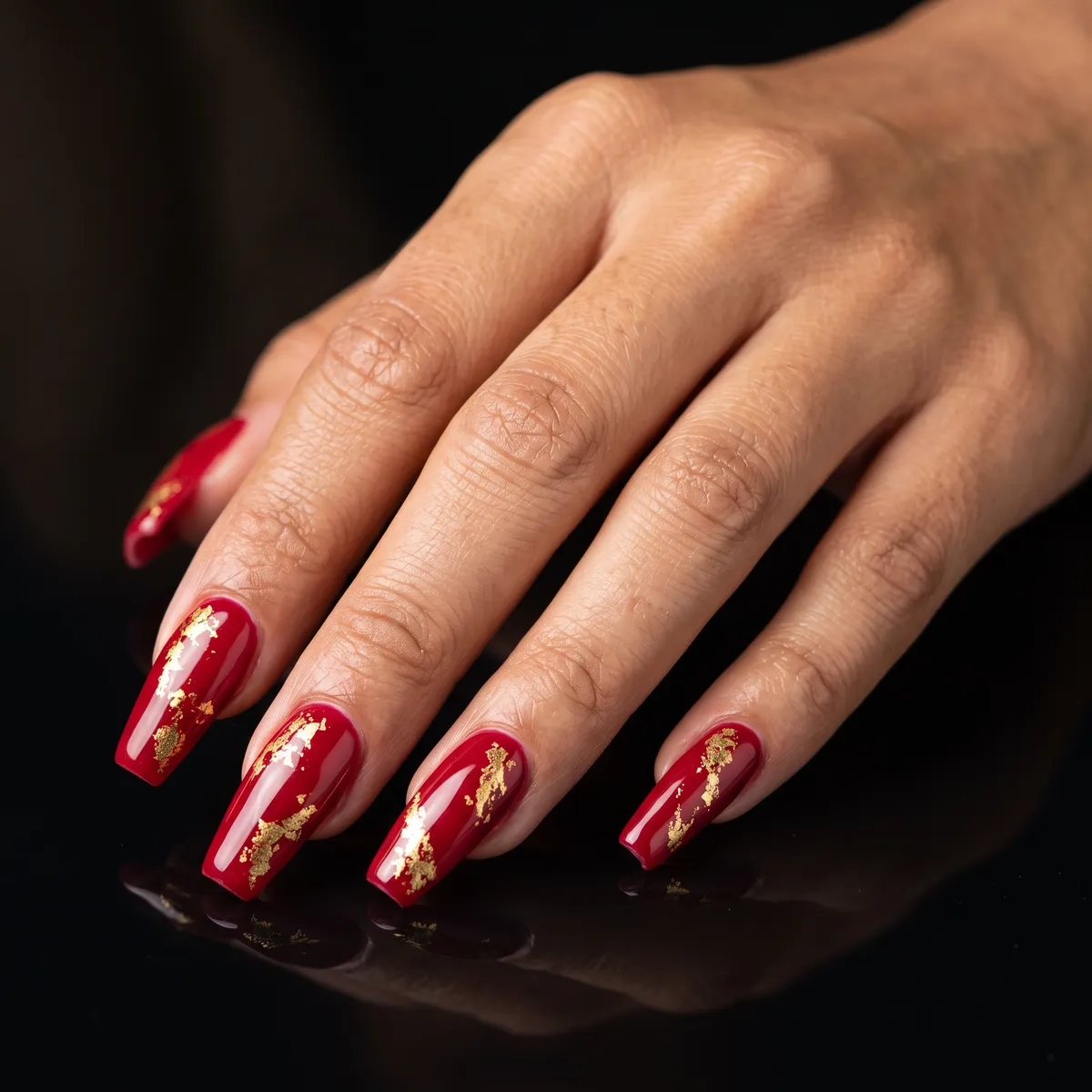 Ruby Foil — coffin red nails with please do a ruby red gel base with pressed gold foil accents on long coffin nails