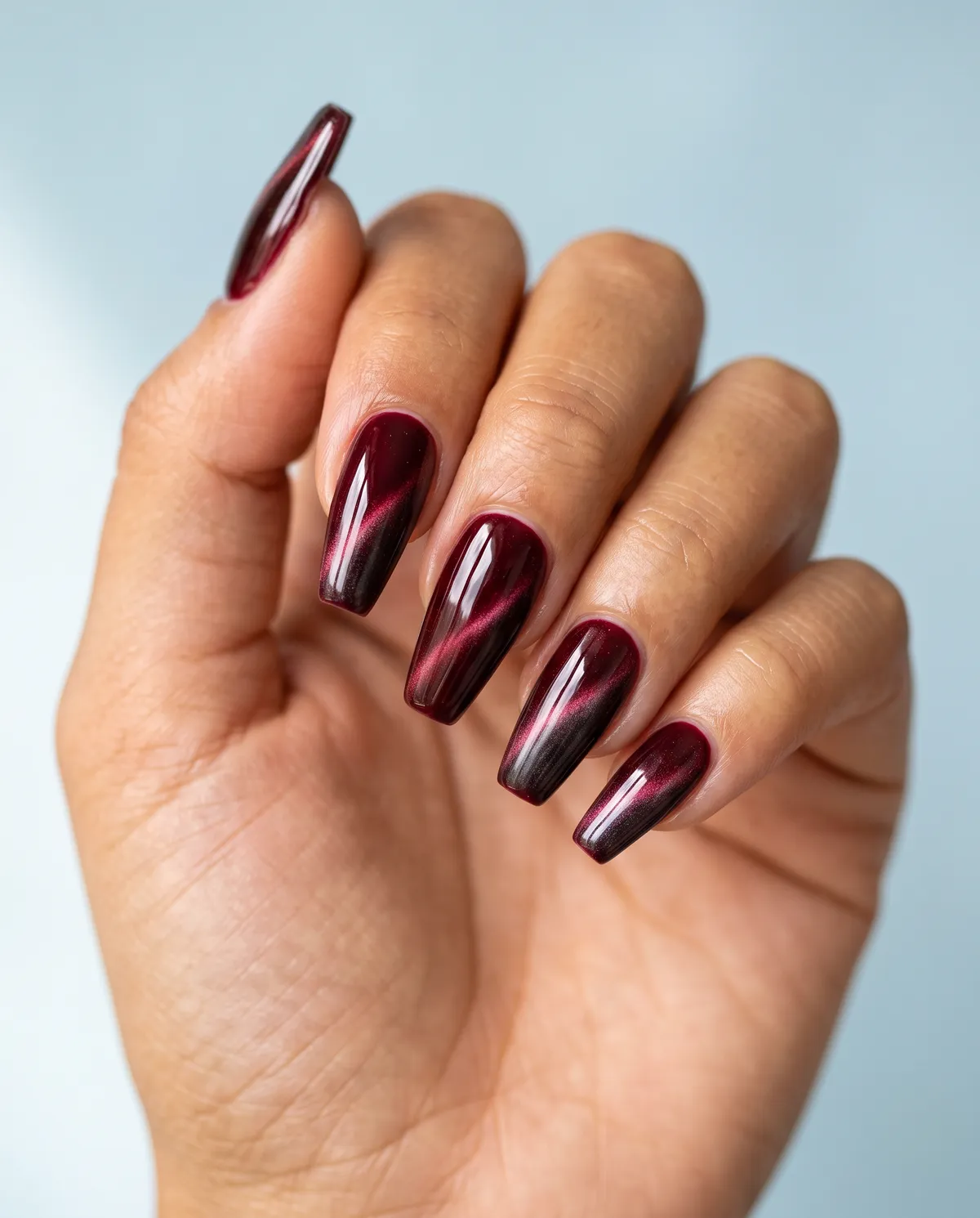 Velvet Noir — coffin red nails with i'd like a deep wine red cat-eye gel with a magnetic light stripe on long coffin nails