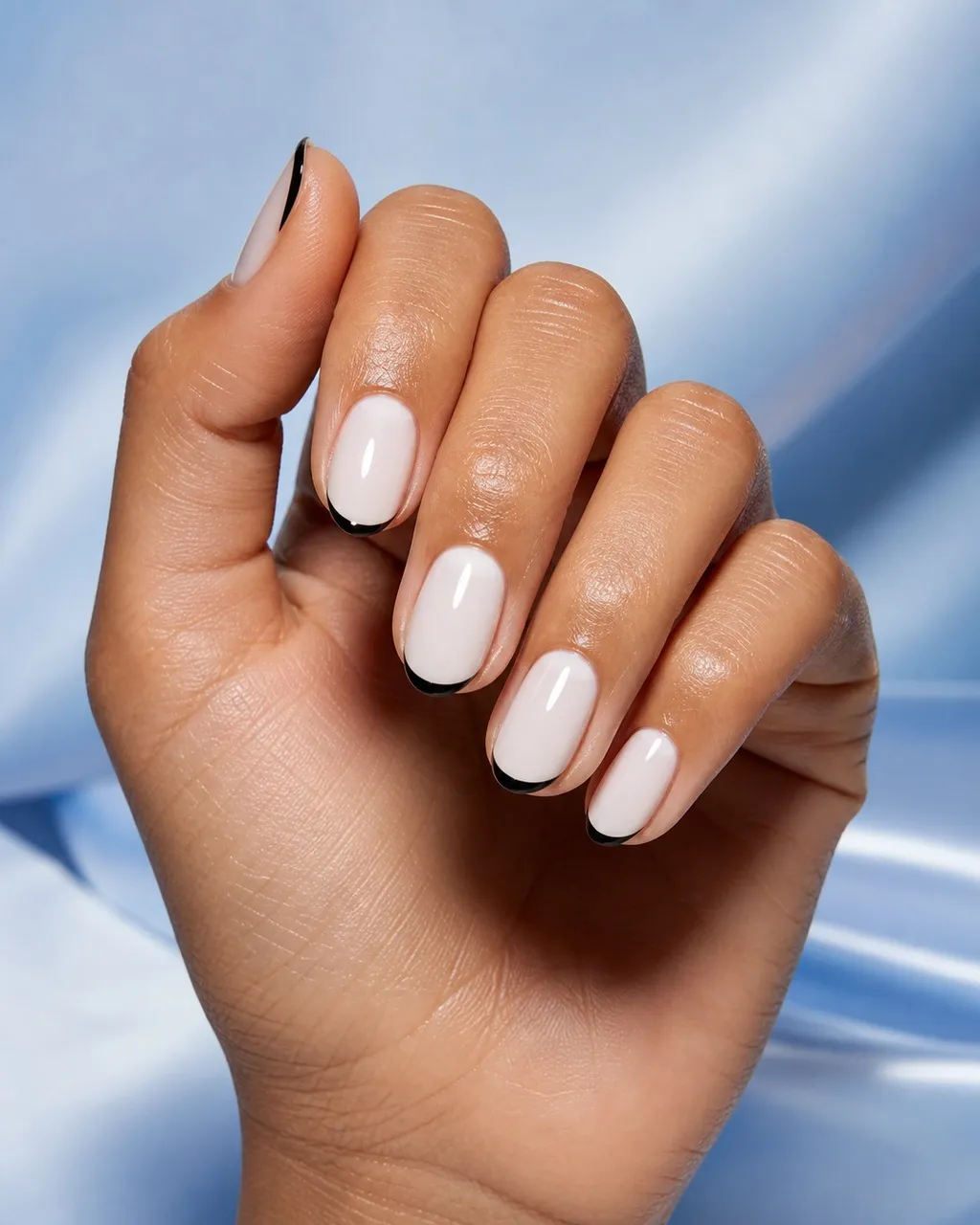Black Micro French — short almond nails with sheer milky base with a very thin black micro french tip at the free edge, glossy, short almond