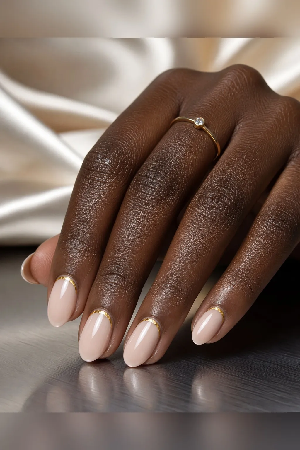 Gold Cuticle Short Almond — short almond nails with sheer nude base with a thin gold foil crescent along the cuticle on every nail, glossy…