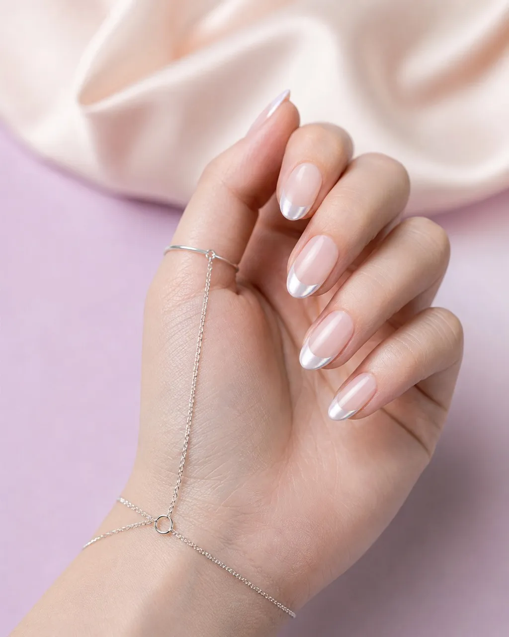 Pearl Tips Short Almond — short almond nails with sheer milky base with pearl chrome powder on the french tips only, soft smile line, glossy…