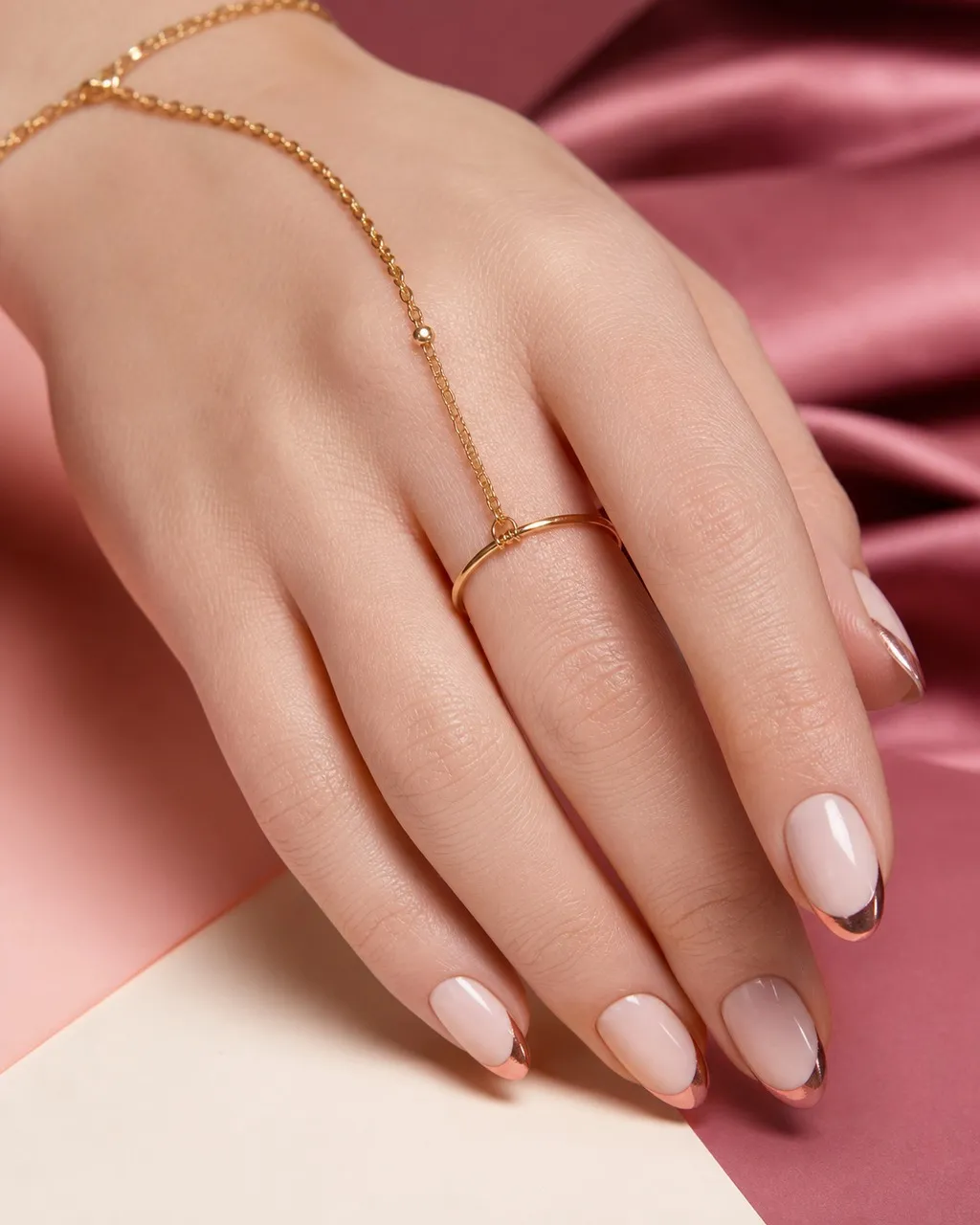 Rose Gold Tips Almond — short almond nails with sheer milky base with rose-gold chrome powder on the french tips only, crisp smile line…