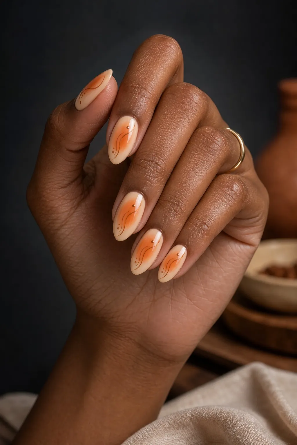 Sweet Potato Aura — almond thanksgiving nails with sheer cream base with a warm orange aura airbrushed in the centre of each nail fading to…