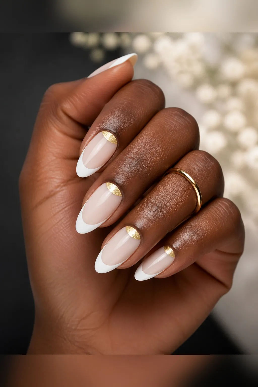 Gold Crescent French — almond french nails with sheer milky base with a white french tip and a thin gold foil crescent along the cuticle on…