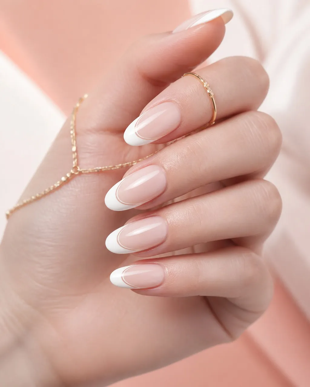 Negative Space White French — almond french nails with sheer natural base with a white french tip framed by a thin bare outline along its…