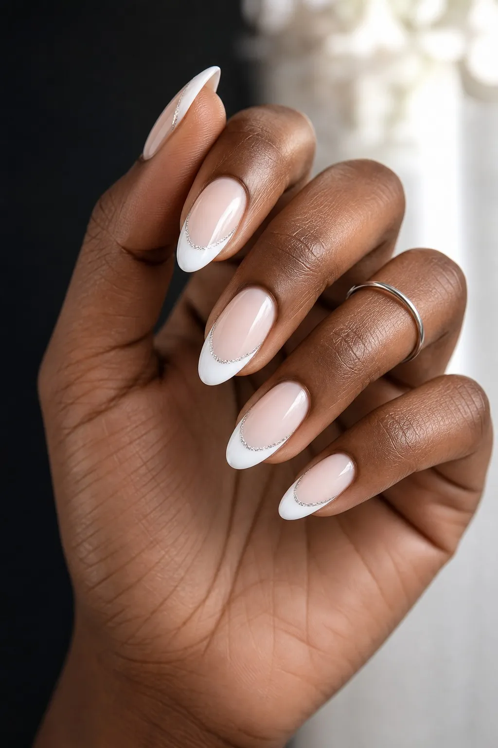 Silver Line French — almond french nails with sheer milky base with a white french tip and a thin silver glitter line along the smile line…